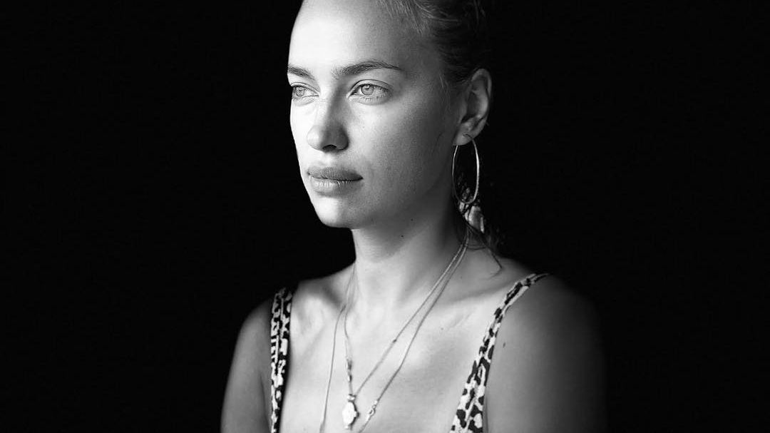 На знімку кохана Бредлі Купера сидить за столом в короткому топі - фото 1