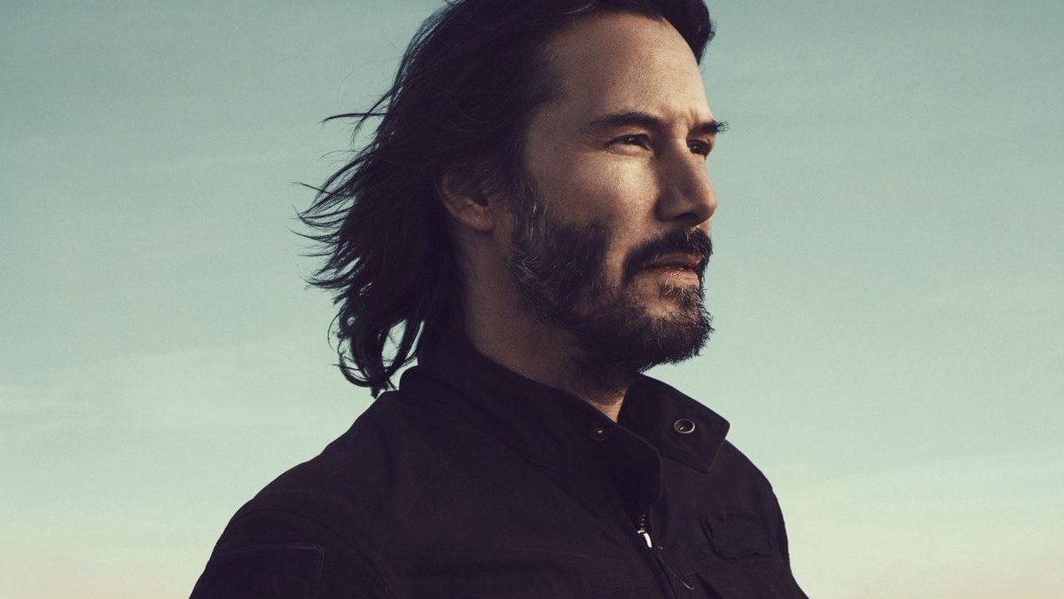 Рівз на фото тримає телефон із зображенням свого портрета - фото 1